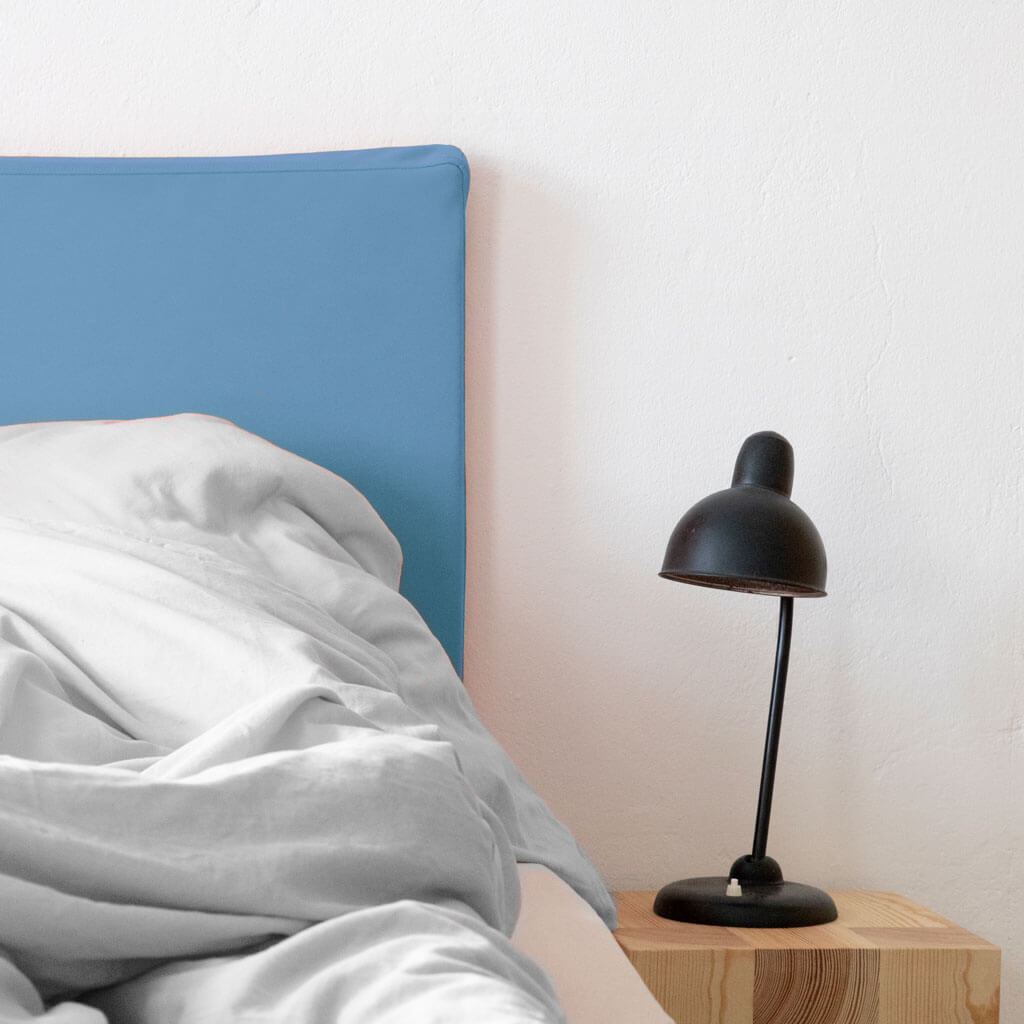 headboard in cornflower blue with grey bed linen
